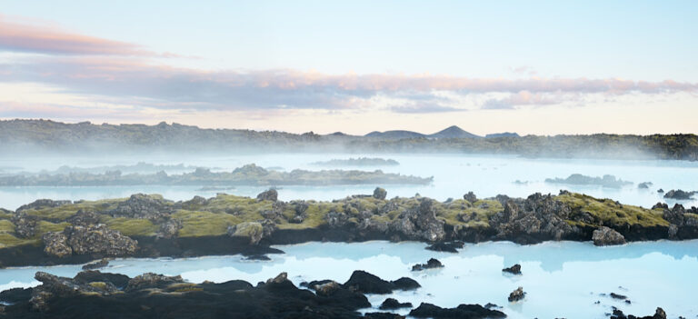 View at mossy lava rocks and blue thermal waters of the Blue Lagoon