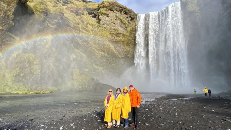 With my guests by the Skógafoss waterfall in Iceland, with a rainbow. Part of the South Coast Tour by Arctic Mike Iceland.