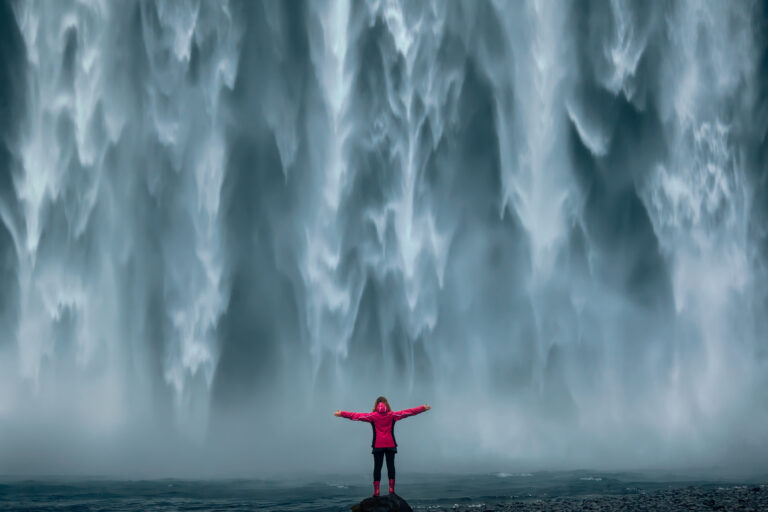 Tourist by the Skógafoss waterfall in Iceland. Part of the South Coast Tour by Arctic Mike Iceland.