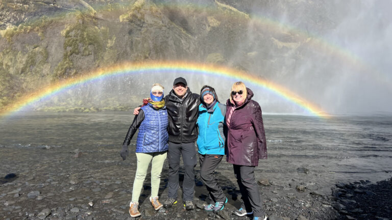 With my guests by the Skógafoss waterfall in Iceland, with a rainbow. Part of the South Coast Tour by Arctic Mike Iceland.