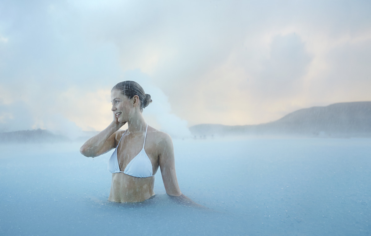 Women are soaking in the geothermal pool of the Blue Lagoon