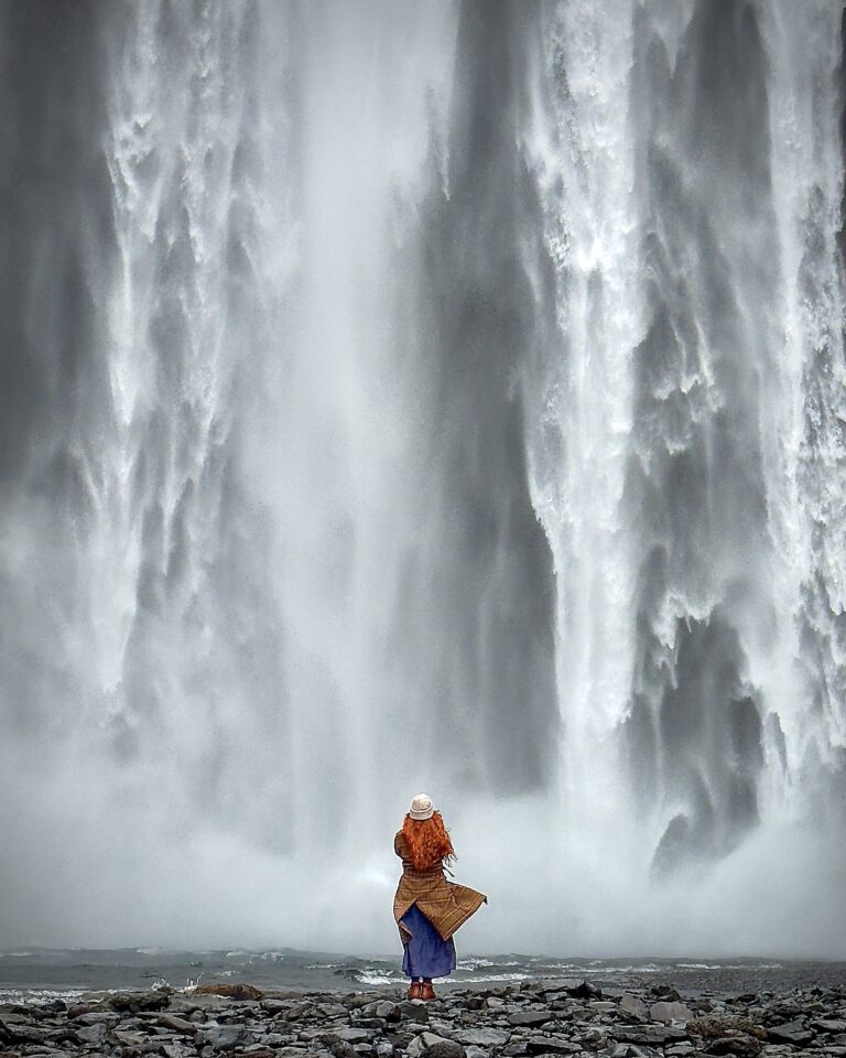 Tourist by the Skógafoss waterfall in Iceland. Part of the South Coast Tour by Arctic Mike Iceland.