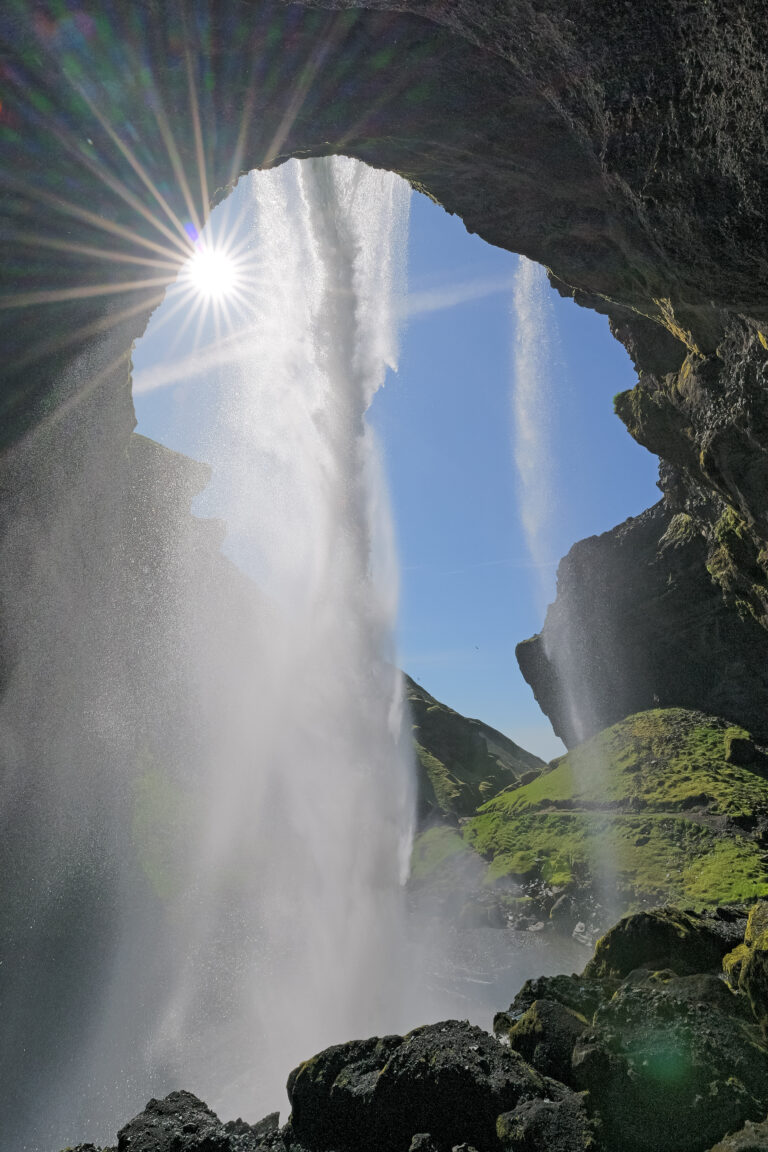 Behind the drop of Kvernufoss Waterfall in Iceland. Part of the South Coast of Iceland Tour by Arctic Mike Iceland.