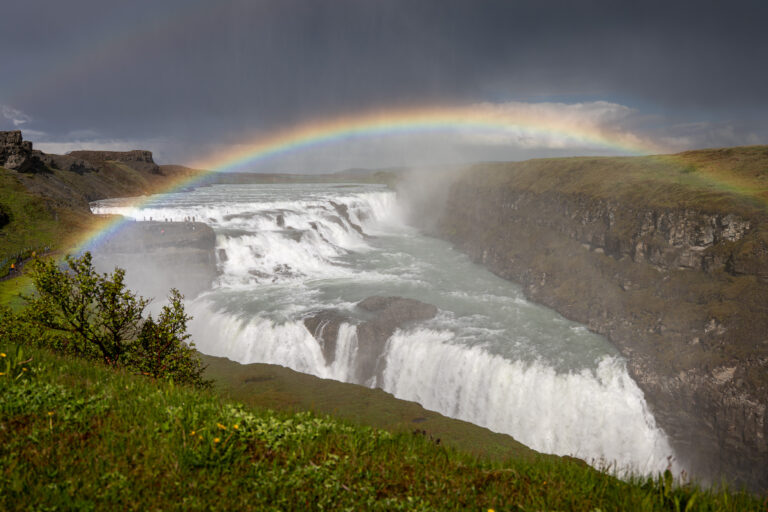 Picture of the view at Gullfoss Waterfall with the rainbow on a summer day.