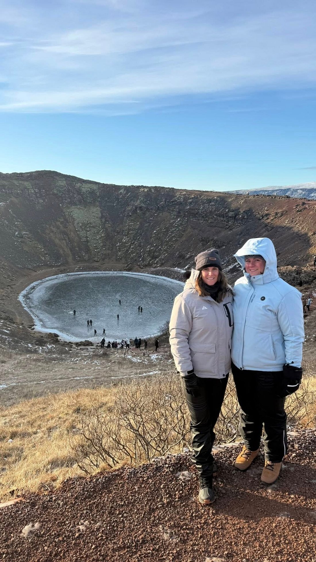 Picture of a tourist at the view of Kerid Krater on a summer day. Part of the Golden Circle tour with Arctic Mike