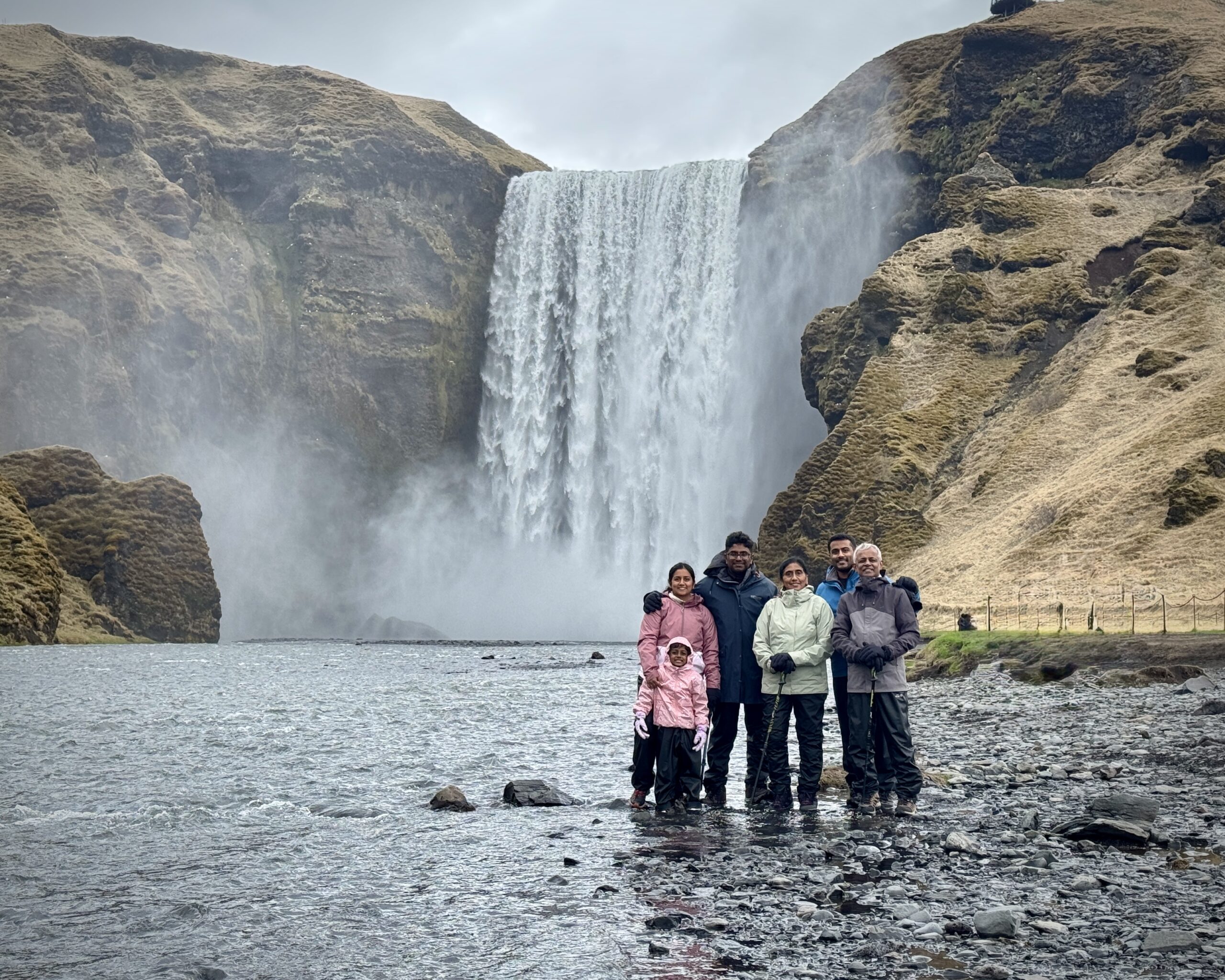 My guests by the Skógafoss waterfall in Iceland, with a rainbow. Part of the South Coast Tour by Arctic Mike Iceland.