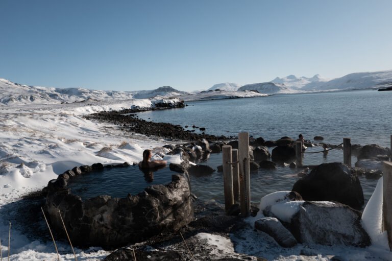 Picture of a woman relaxing in Hvammsvik hot spring