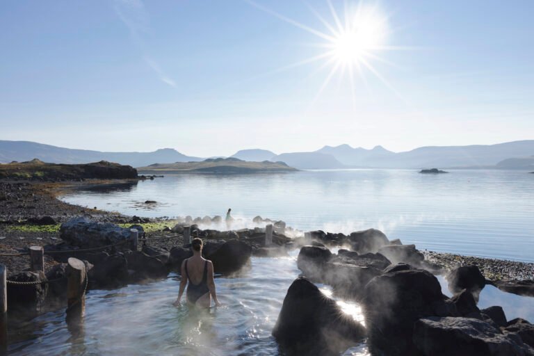Picture of a woman relaxing in Hvammsvik hot spring